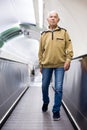 Retired man walking down the escalator to metro station Royalty Free Stock Photo