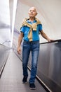 Retired man walking down the escalator to metro station Royalty Free Stock Photo