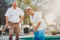 Retired married elderly couple playing mini golf together Royalty Free Stock Photo