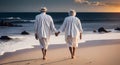 retired ouple white dressed walking on the beach - sunset