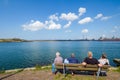Retired people look across the water on the North Sea coast to m