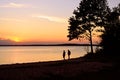 Retired people walking on the beautiful morning beach during sunrise Royalty Free Stock Photo