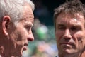 Retired players, Pat Cash and John McEnroe in conversation before the start of the men`s finals on centre court. Royalty Free Stock Photo