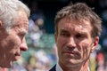 Retired players, Pat Cash and John McEnroe in conversation before the start of the men`s finals on centre court. Royalty Free Stock Photo