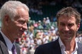 Retired players, Pat Cash and John McEnroe in conversation before the start of the men`s finals on centre court. Royalty Free Stock Photo