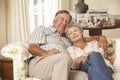 Retired Senior Couple Dozing On Sofa At Home Together