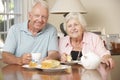 Retired Senior Couple Enjoying Afternoon Tea Together At Home Royalty Free Stock Photo