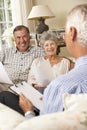 Retired Senior Couple Sitting On Sofa Talking To Financial Advisor Royalty Free Stock Photo