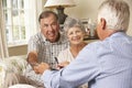 Retired Senior Couple Sitting On Sofa Talking To Financial Advisor Royalty Free Stock Photo