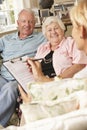 Retired Senior Couple Sitting On Sofa Talking To Financial Advisor Royalty Free Stock Photo