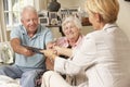 Retired Senior Couple Sitting On Sofa Talking To Financial Advisor Royalty Free Stock Photo