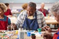 Retired Senior Man Attending Art Class In Community Centre