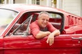 Retired Senior Man Sitting In Restored Classic Car