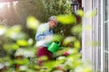 Retired man watering plants in the garden Royalty Free Stock Photo