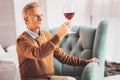 Retired wine expert drinking tasty red wine