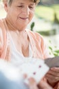 Retired woman playing cards