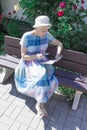 Retired woman reading newspaper outdoors Royalty Free Stock Photo