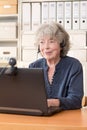 Retired woman smiling into webcam Royalty Free Stock Photo