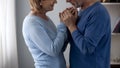 Retiree couple holding hands, looking at each other with love and gratefulness Royalty Free Stock Photo