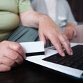 Retiree couple shopping online using laptop