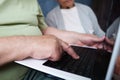 Retiree couple surfing internet using laptop