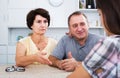 Retiree couple talking with daughter