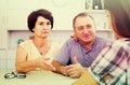 Retiree couple talking with daughter