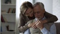 Retiree lady hugging man, loving relations in long marriage, closeness and care