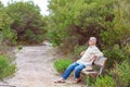 Retiree Sitting On Park Bench