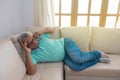 A retiree talking on his cell phone on the couch at home Royalty Free Stock Photo