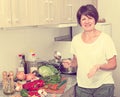 Retiree woman cooking soup