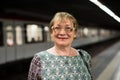 Retiree woman passenger in train station