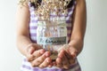 A retirement concept jar with coins and dried plant Royalty Free Stock Photo