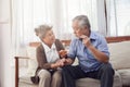 Retirement couples take care of each other when they are sick, sitting on the couch in the house without the children to look Royalty Free Stock Photo