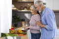 Retirement Leisure. Smiling Senior Spouses Cooking Lunch Together In Kitchen Interior Royalty Free Stock Photo