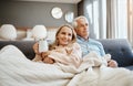 Retirement means more time for quality time. a happy mature couple relaxing on the sofa at home. Royalty Free Stock Photo