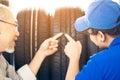 Retirement man touching and choosing for buying a tire in a supermarket mall. Measuring rubber car wheel