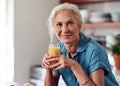 Retirement mornings couldnt be more perfect. Cropped portrait of an attractive senior woman enjoying a glass of orange Royalty Free Stock Photo