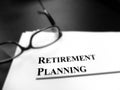 Retirement Planning Documents on Desk with Glasses Blur Focus Royalty Free Stock Photo