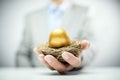 Retirement savings golden nest egg in businessman hand Royalty Free Stock Photo