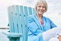 Retirement was made to rest and relax. Portrait of a happy senior woman relaxing on a chair outside. Royalty Free Stock Photo