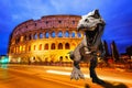 Dinosaurs model on Twilight view of Colosseum in Rome