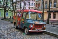 Retro abandoned car painted graffiti in the hippy style on one of the streets of Lviv Royalty Free Stock Photo