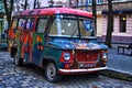 Retro abandoned car painted graffiti in the hippy style on one of the streets of Lviv Royalty Free Stock Photo