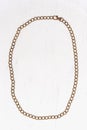 Retro accessory golden belt chain laid out in a rounded frame on a white background