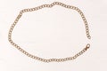 Retro accessory of metal belt chain laid out in a rounded frame on a white background