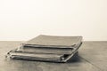 Retro aged books on oak wooden table. Vintage style sepia photo