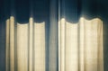 Retro aged curtain drapes on sunny window