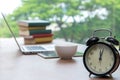 Retro alarm clock with cup of cappuccino on table in office, Coffee Break lunch time Royalty Free Stock Photo
