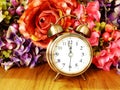 Retro alarm clock with flowers background Royalty Free Stock Photo